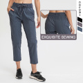 Nuevos pantalones de yoga Pantalones de mujeres con cordón con cordón y bolsillos Mujeres Pantalones deportivos Capri tejido febric febric pantalones de chándal esenciales